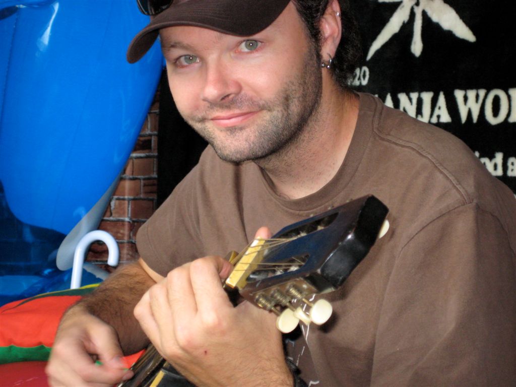 Jason playing a guitar with 5 strings